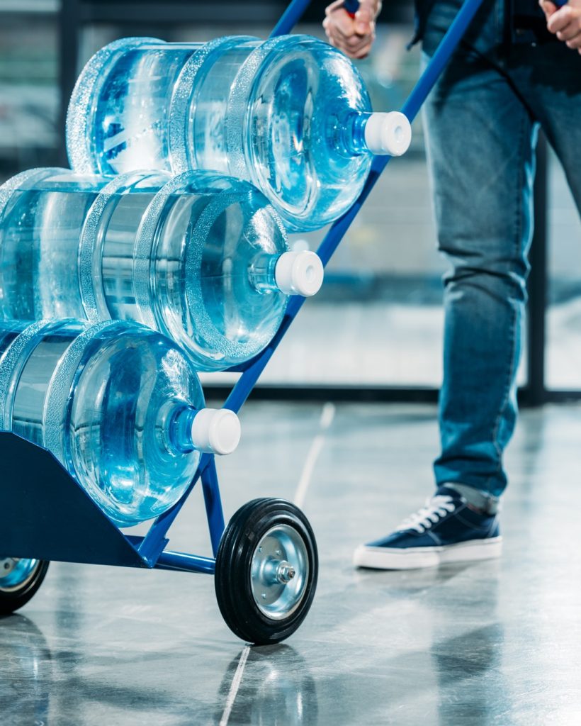 loader-pushing-cart-with-water-bottles.jpg